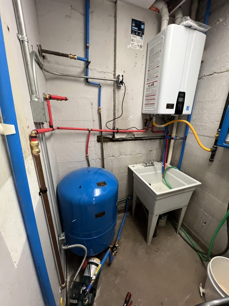 Wall-mounted tankless water heater installation by Marc Francis Plumbing